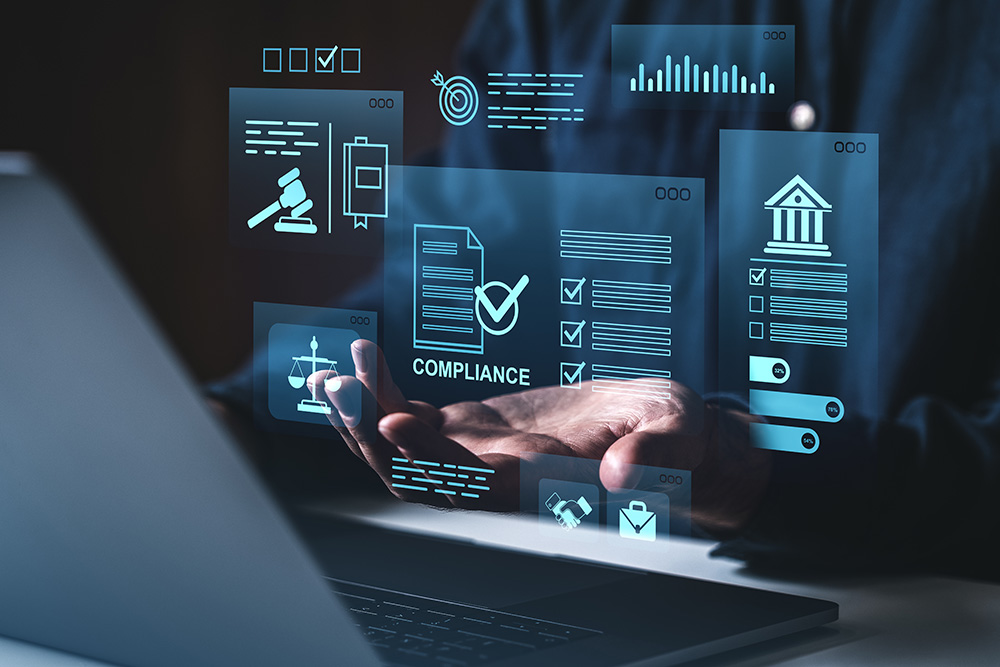 Person working on computer with graphics that show compliance